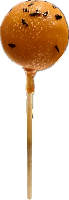 Halloween cake pop in a smooth orange shell with black flecks, black velvet cake inside
